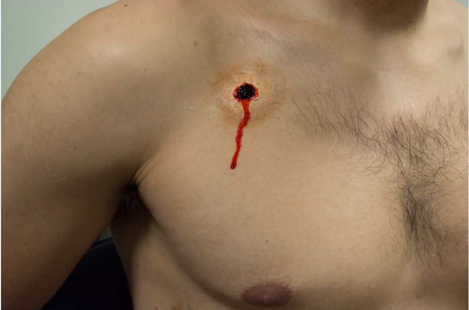 A man with blood dripping from his chest.